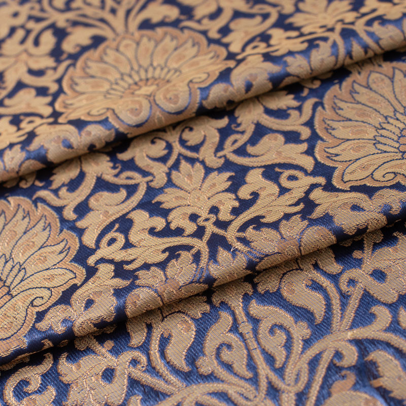 Stof-brokaat-90cm-blauw-en-goud-
met-bloemen