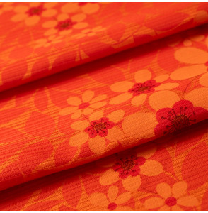 Vintage-meubelstof-jaren-70-oranje-bloemen-op-een-oranje-achtergrond